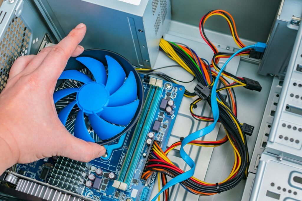 Installing a processor fan on the computer motherboard. Computer repair, PC assembly